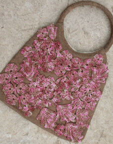 crochet flowers decorate a handbag