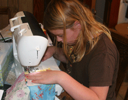 Ella sews patches